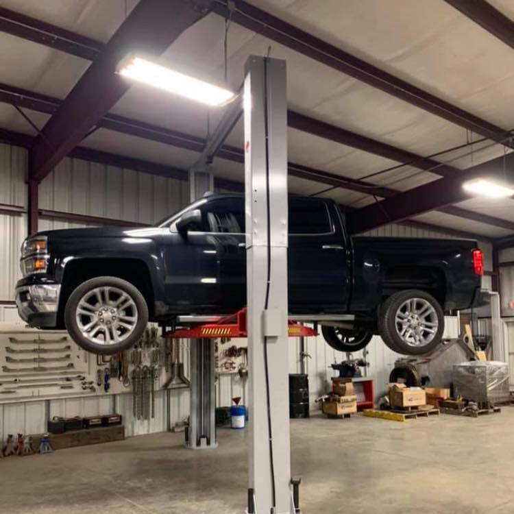 Trucks being serviced on lifts in Griffin Auto Service garage